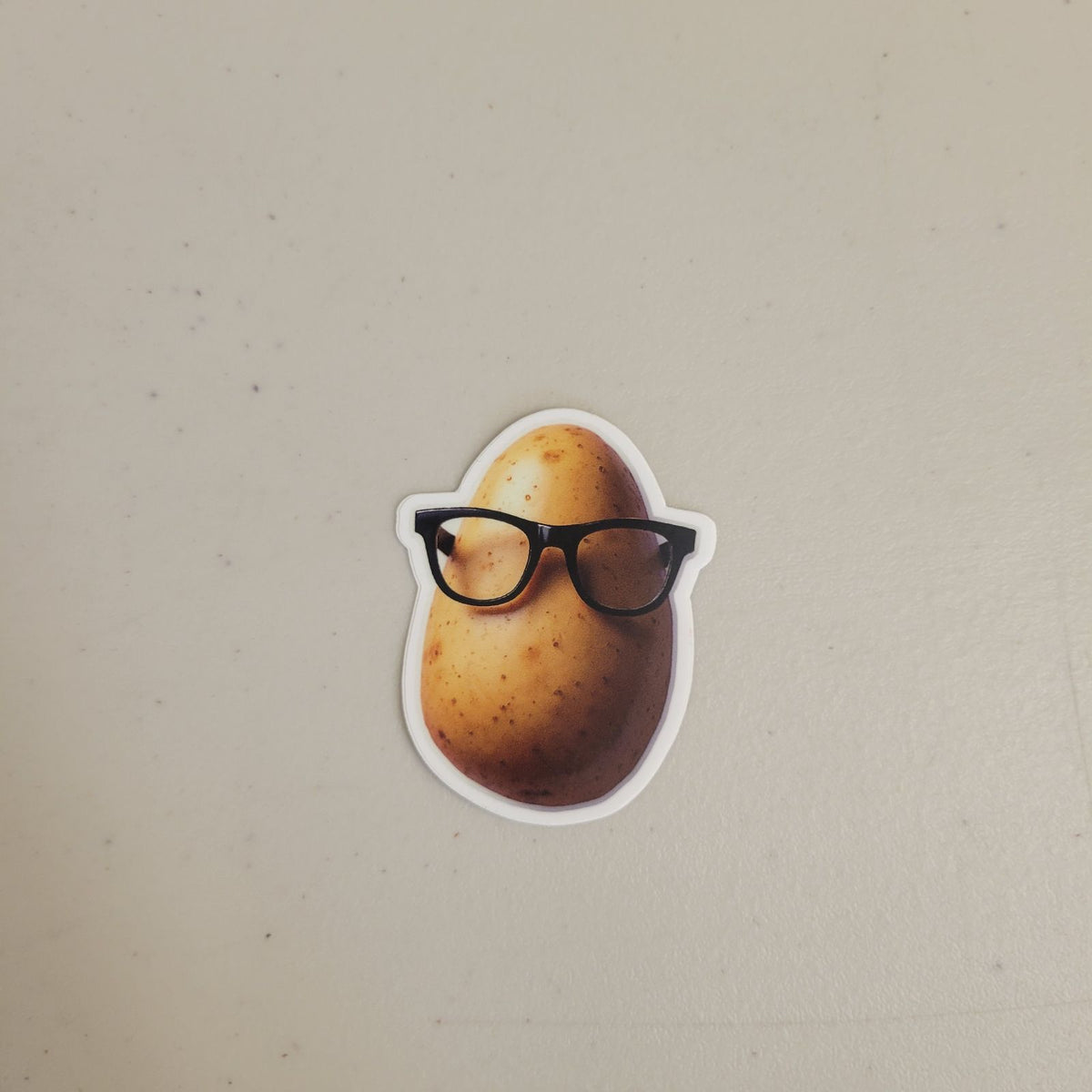 Potato Defense Fund swag illustration of a potato character wearing glasses, close-up