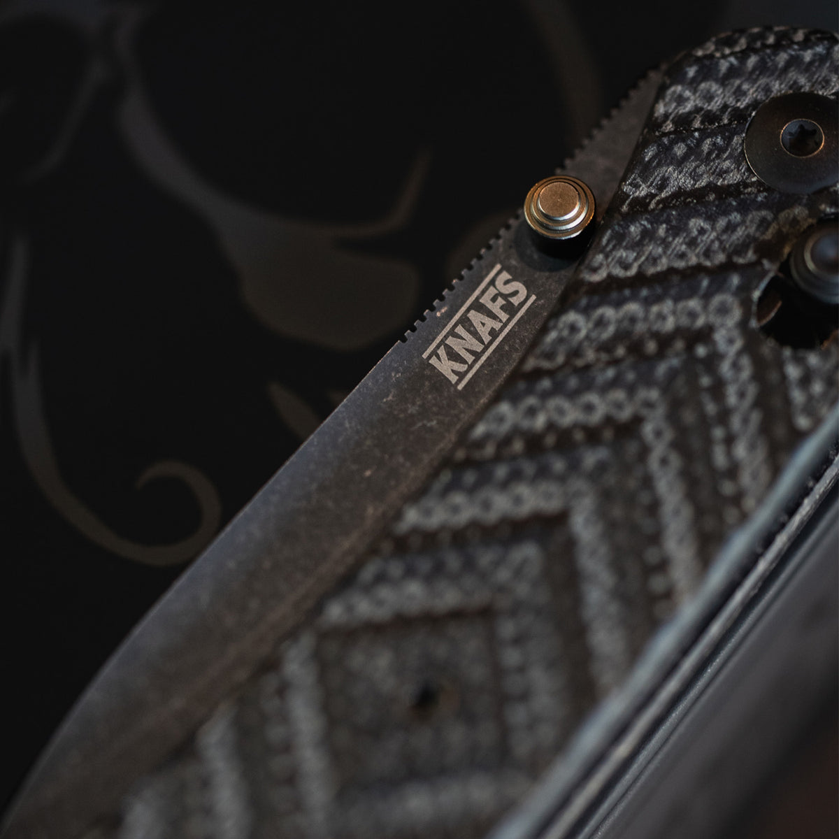 Close-up of Jeremy Siers Lander 2 knife pocket clip and textured micarta handle