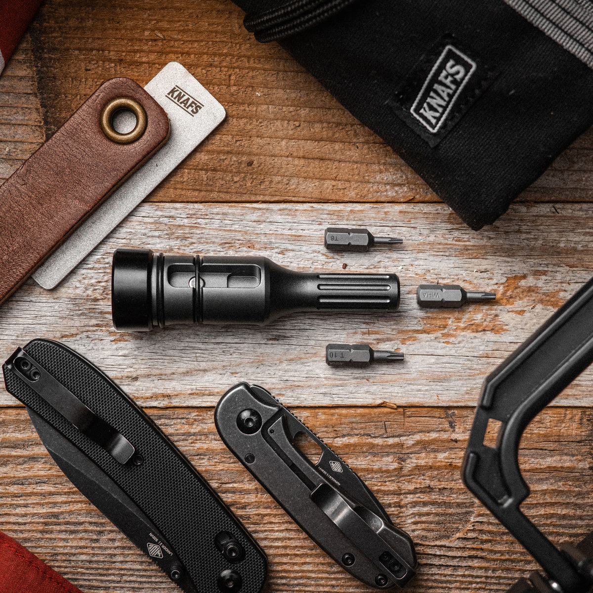 Bit Driver Grande bit driver tool and knife laid out on open EDC pouch