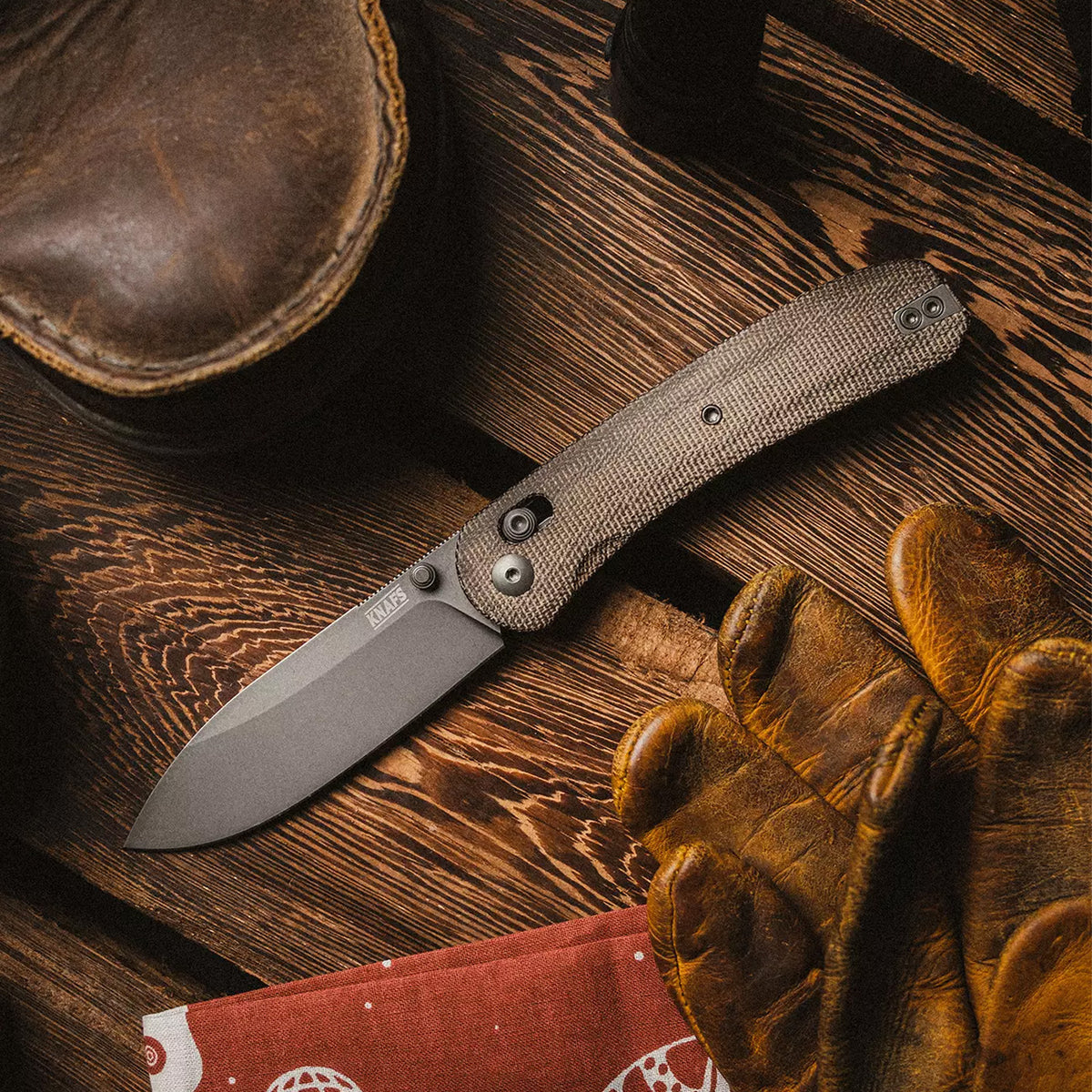 Lander 2 Pocket Knife in Moondust Micarta, open, on a wood table, alternate angle