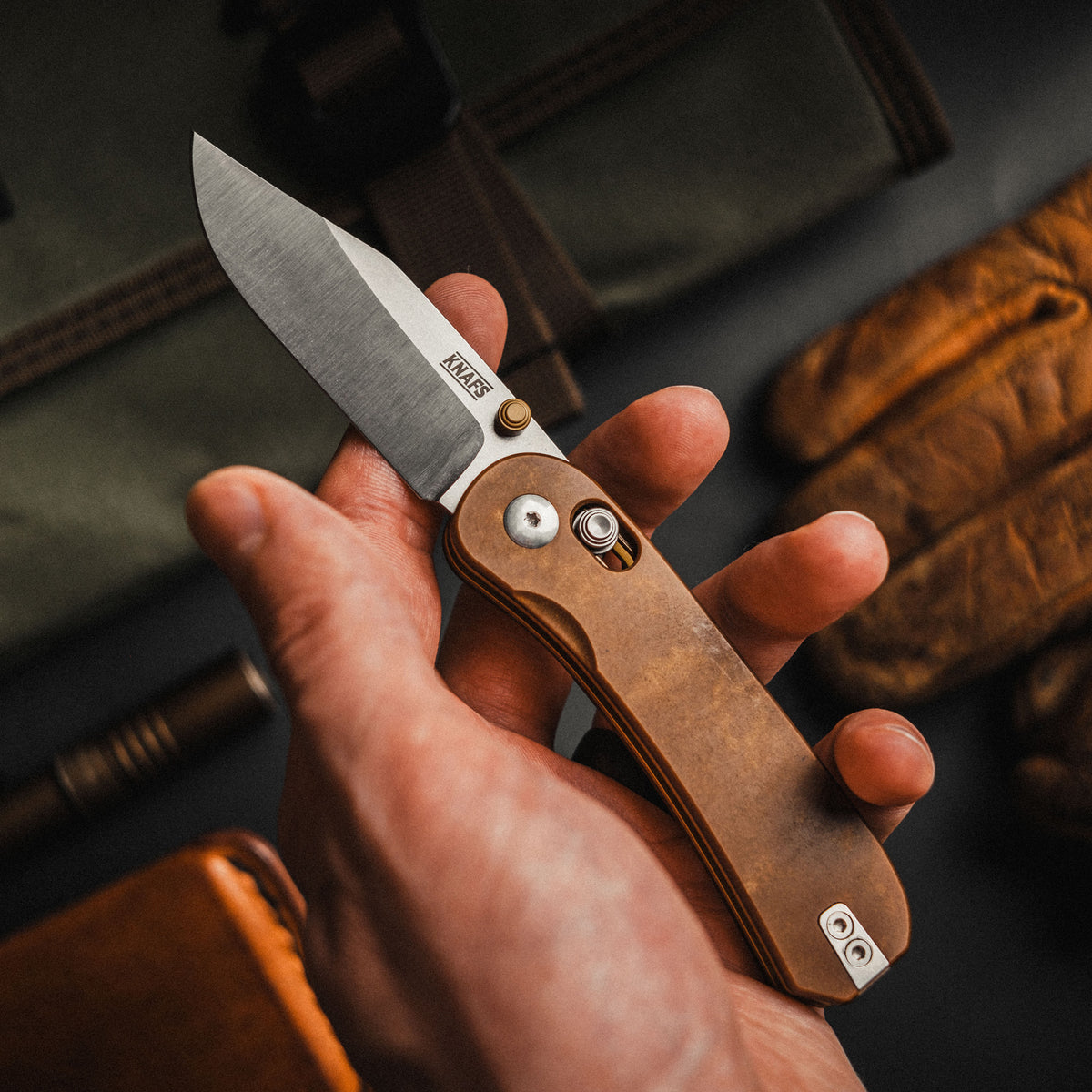 Lander 3 pocket knife with tan handle held in hand, open