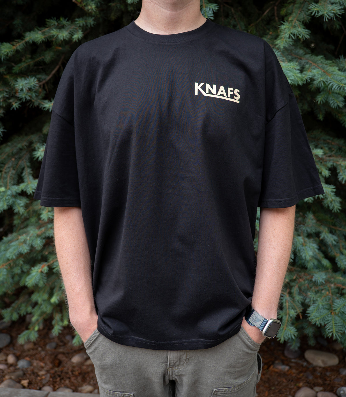 Man wearing black Knafs Quality Knives and High Fives t-shirt, outdoors