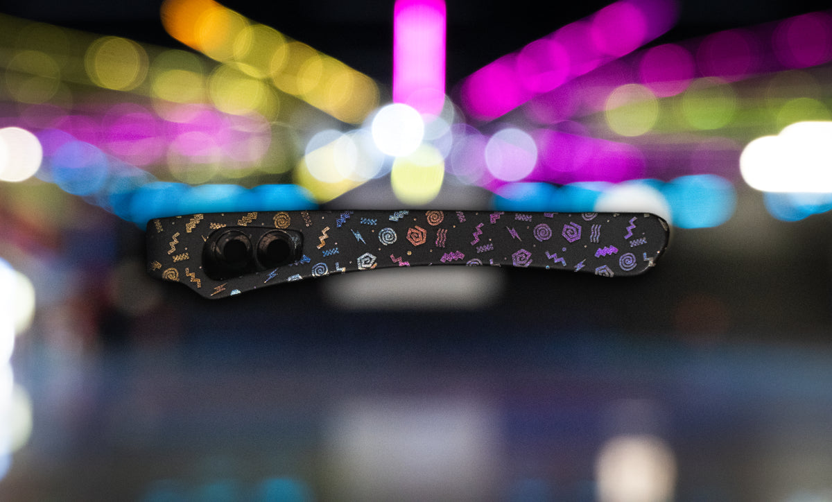 a closed knife with neon colored background