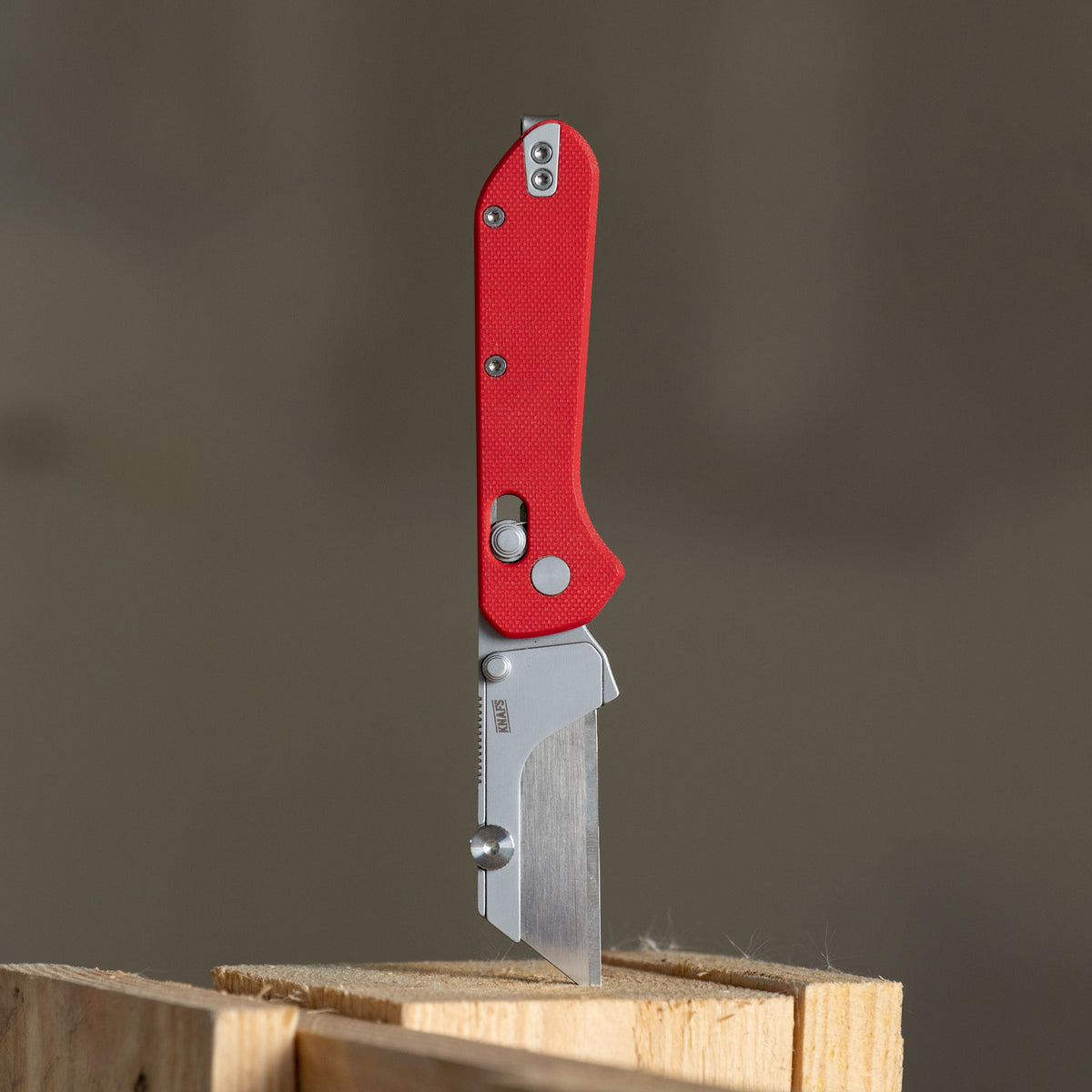 Yuti utility knife with red G10 handle, closed, square product shot