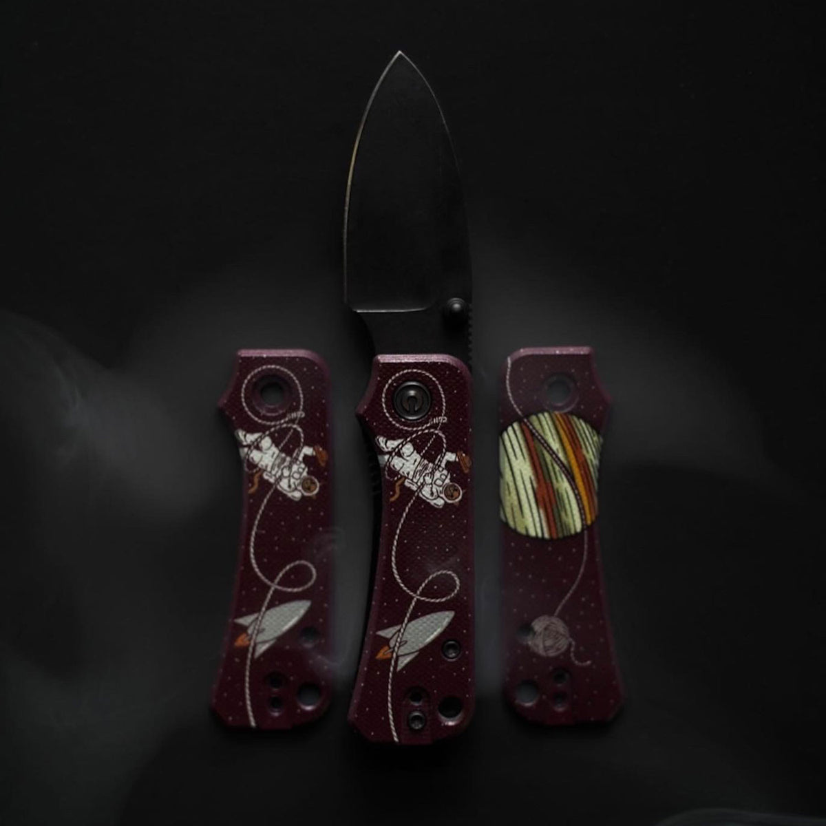 Two Jupiter Space Kitty Baby Banter Scales knives, open and closed, standing upright side by side