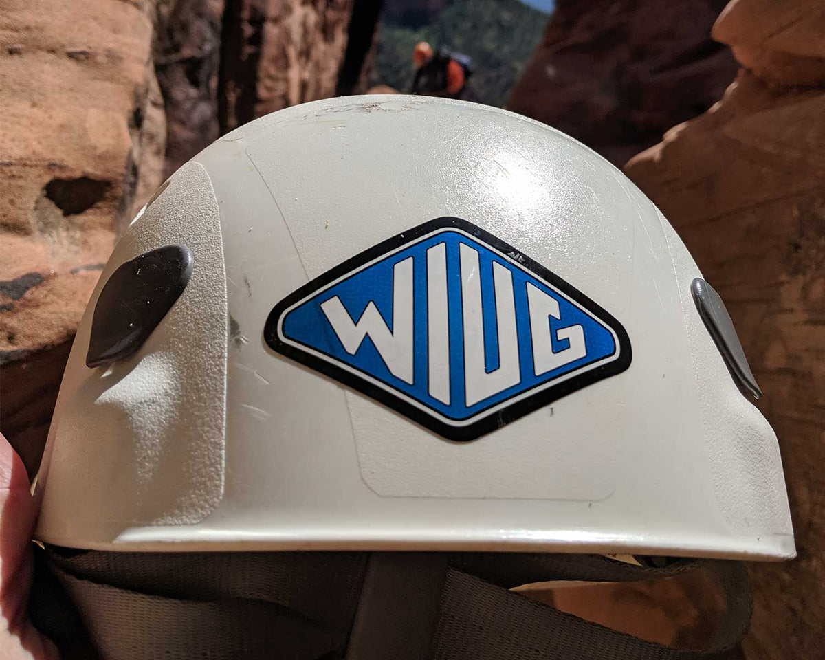 Knafs WIUG sticker applied to a white climbing helmet