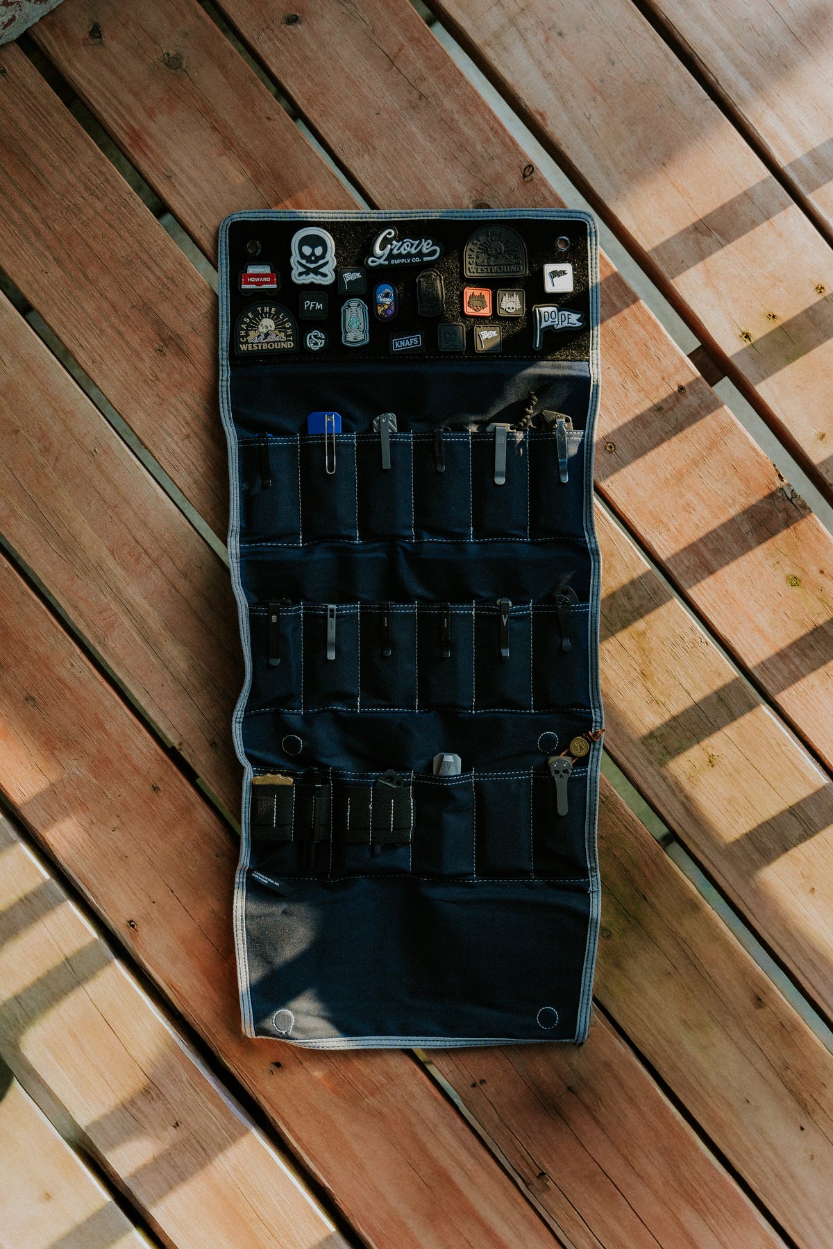Burrito Grande Navy Blue Edition EDC knife roll hanging open showing tool pockets