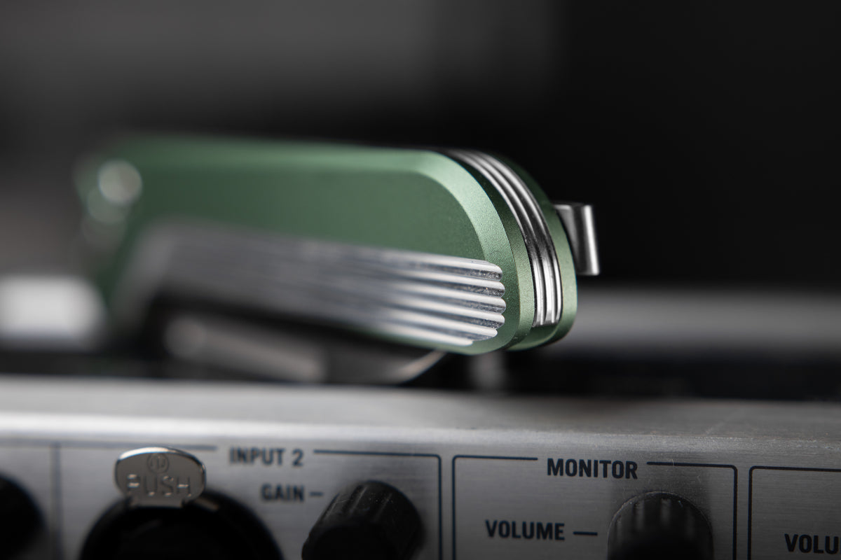 Capcom pocket knife with Mission Control green handle teaser image on dark background