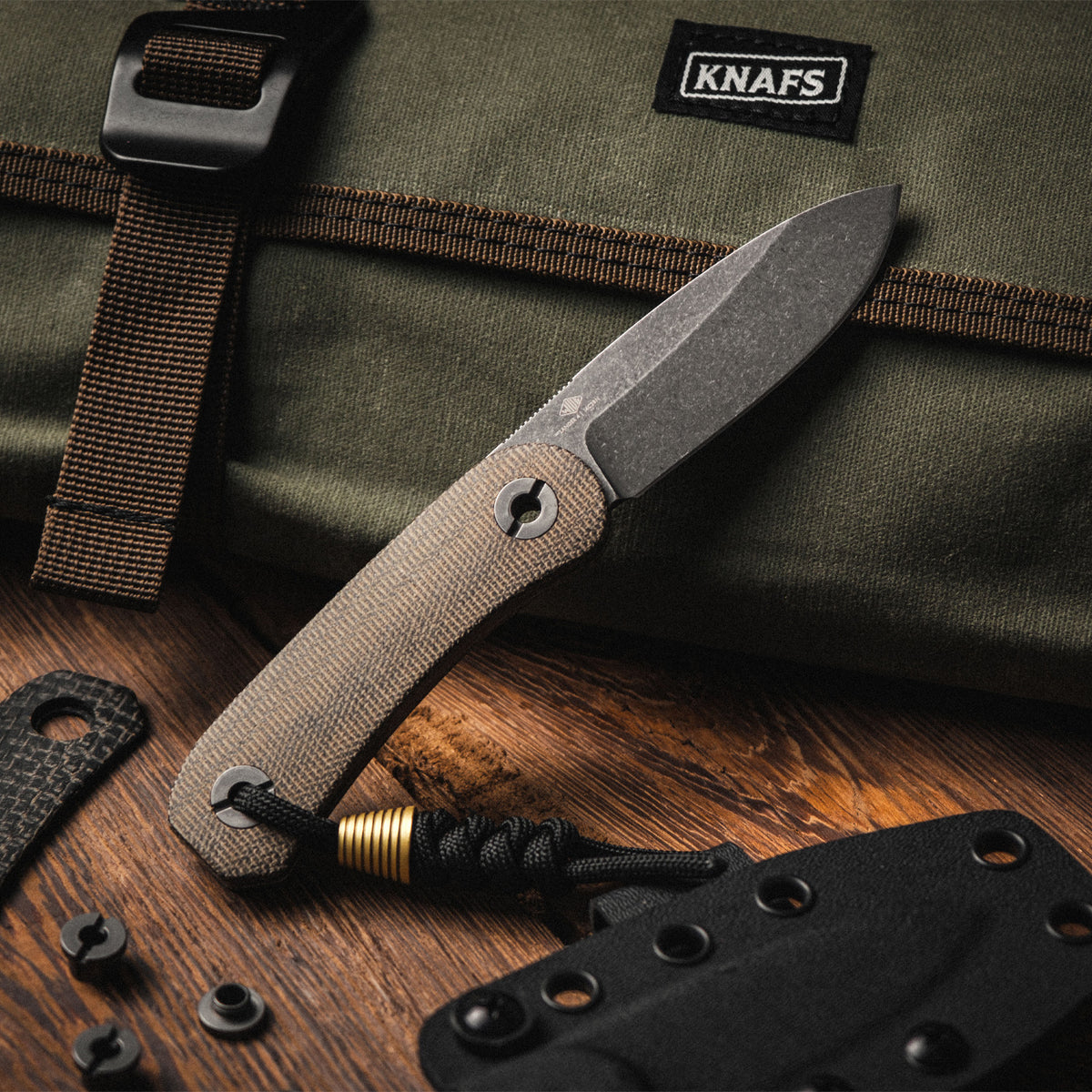 Lander 4 Fixed Blade Knife in Moondust Micarta lying on a wood workbench