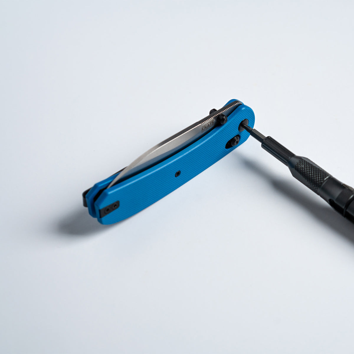 Lander 2 Pocket Knife in Blue G10, closed, standing on a white surface