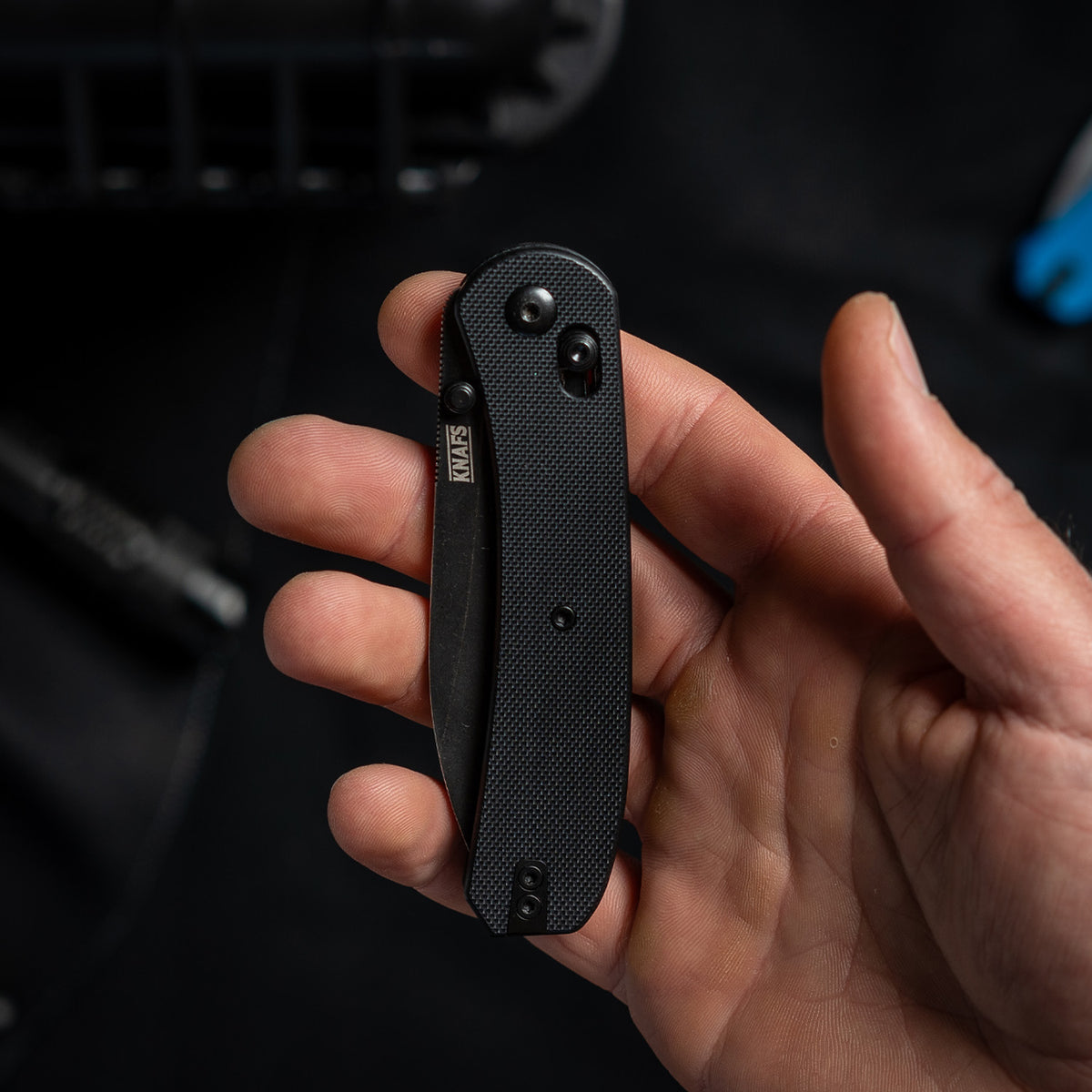Lander 2 Pocket Knife in Black G10, closed, held in hand, close-up