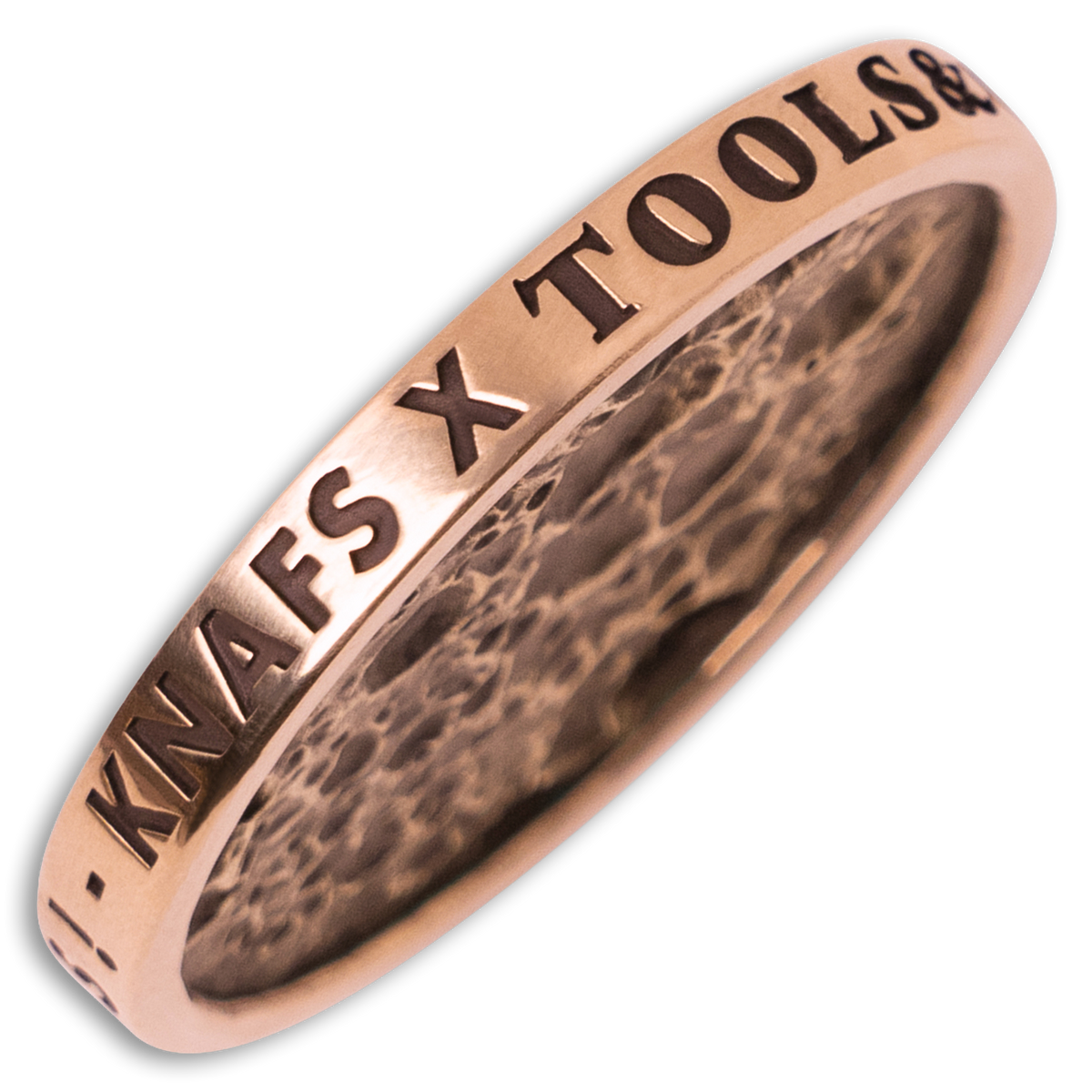 A rose gold ring engraved with 'KNAFS X TOOLS' on the outer band, showing a textured interior, set against a plain white background.