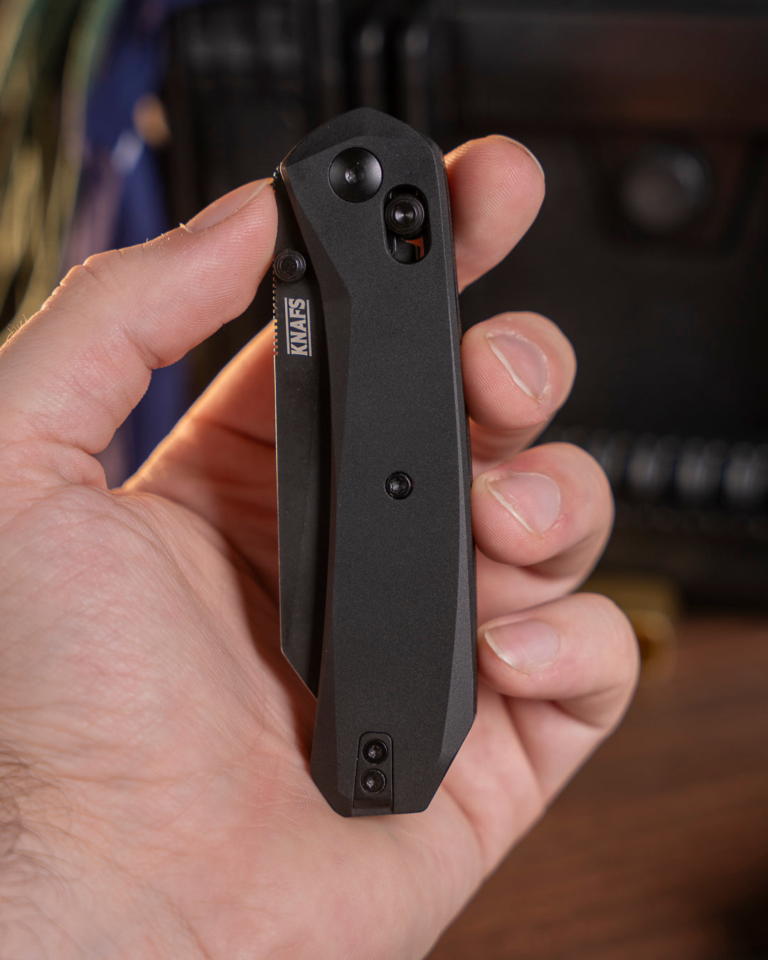 Hand holding closed Lander 2 Reverse Tanto pocket knife with black aluminum handle