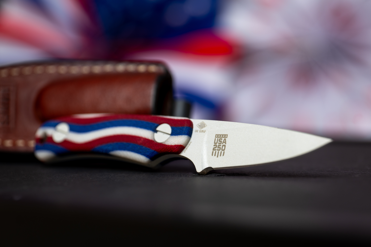 Little Lulu fixed blade knife with red white and blue handle in brown leather sheath