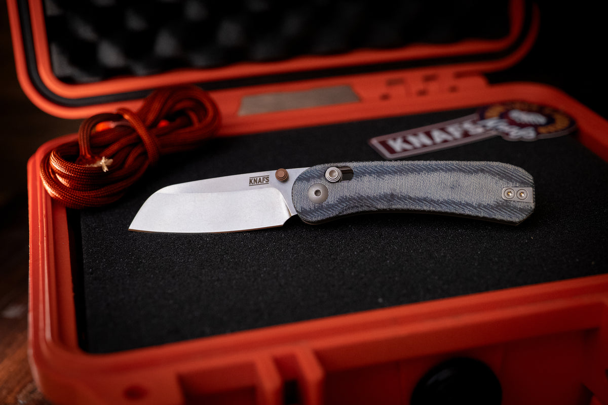 Lander 3 sheepsfoot pocket knife, open, resting in orange hard case foam insert