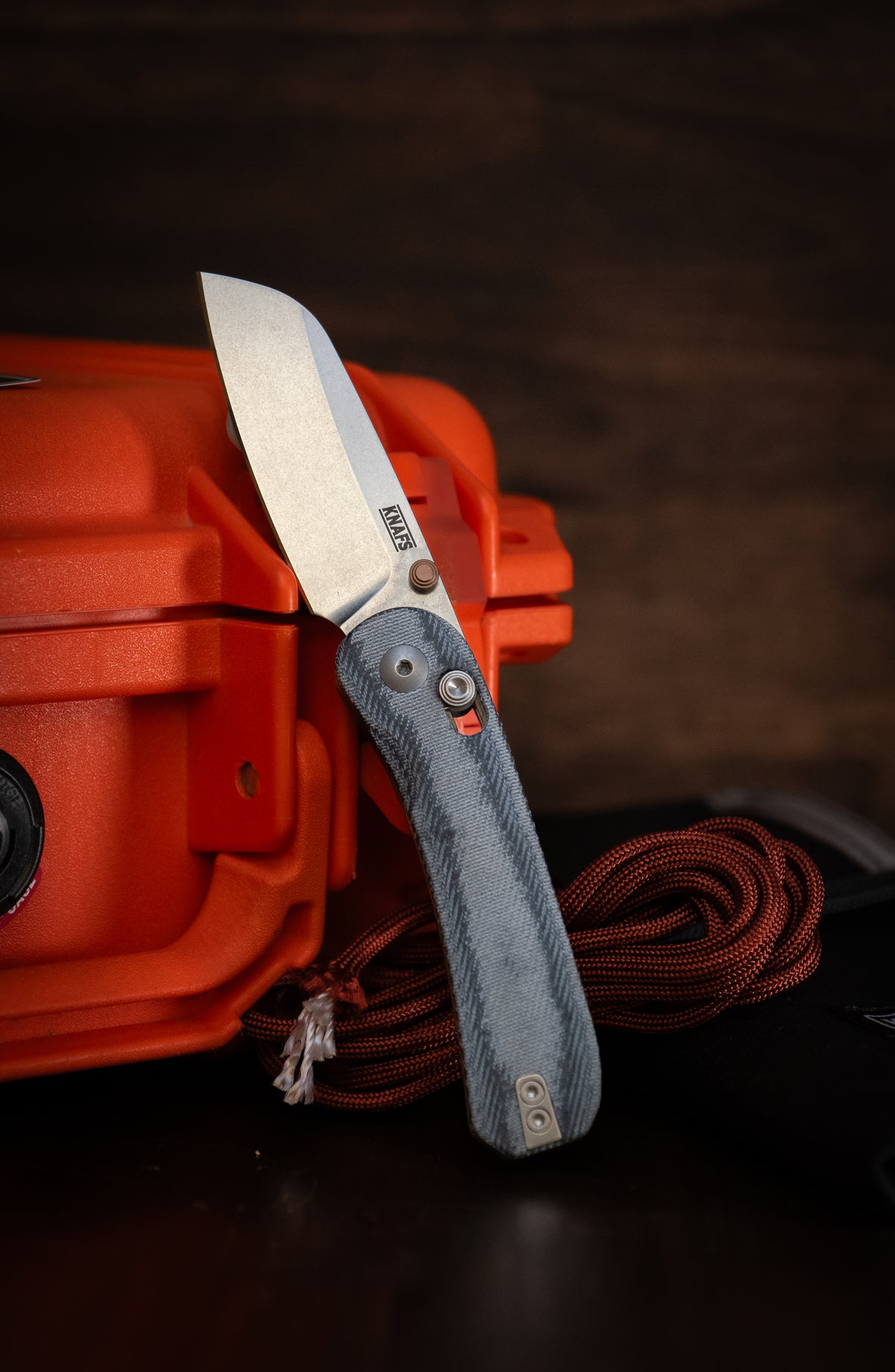 Lander 3 sheepsfoot pocket knife closed, leaning against orange hard case
