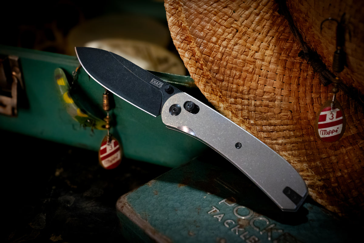 Lander 2 stonewash titanium pocket knife clipped to canvas bag outdoors