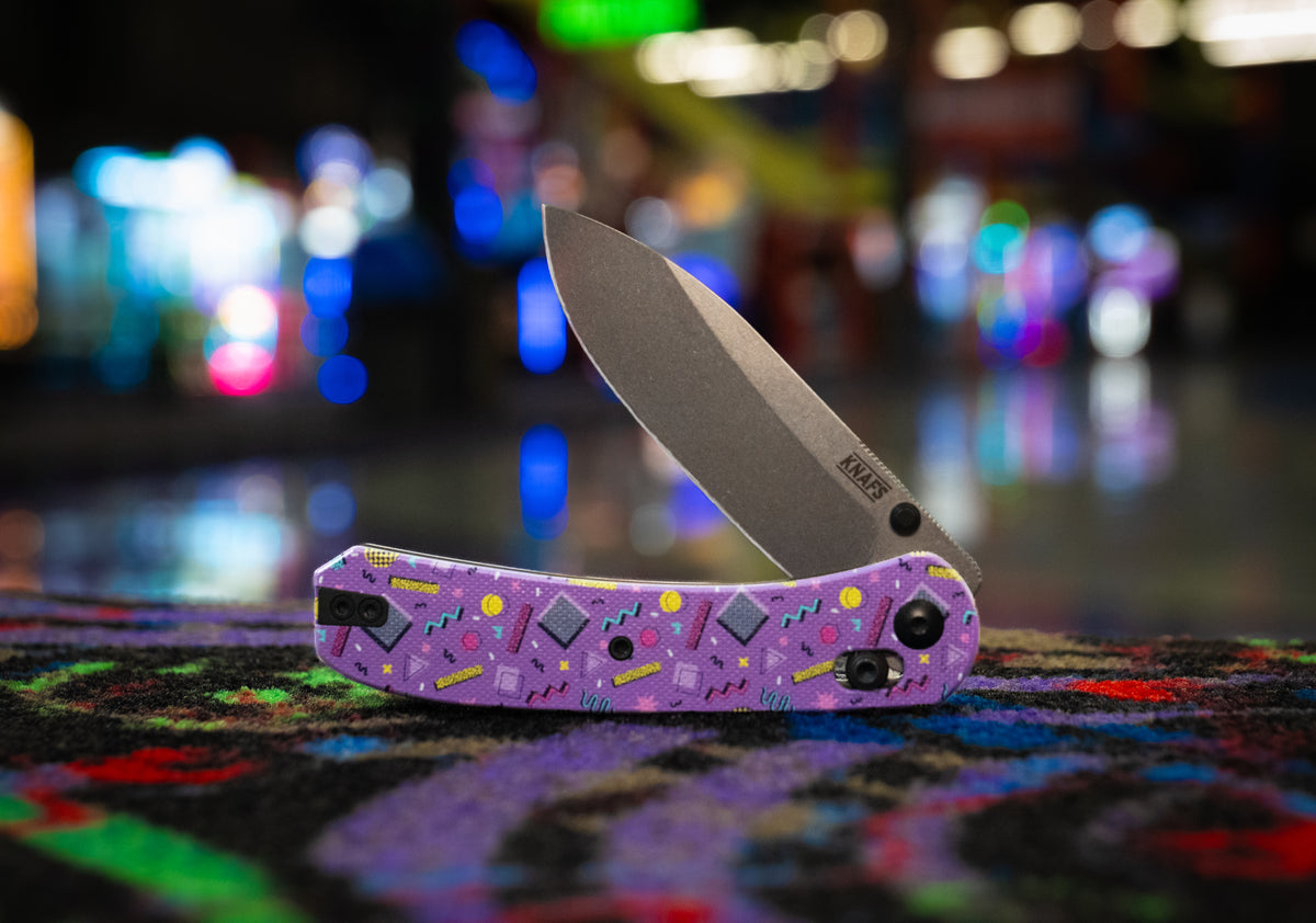 a folding knife with a purple handle