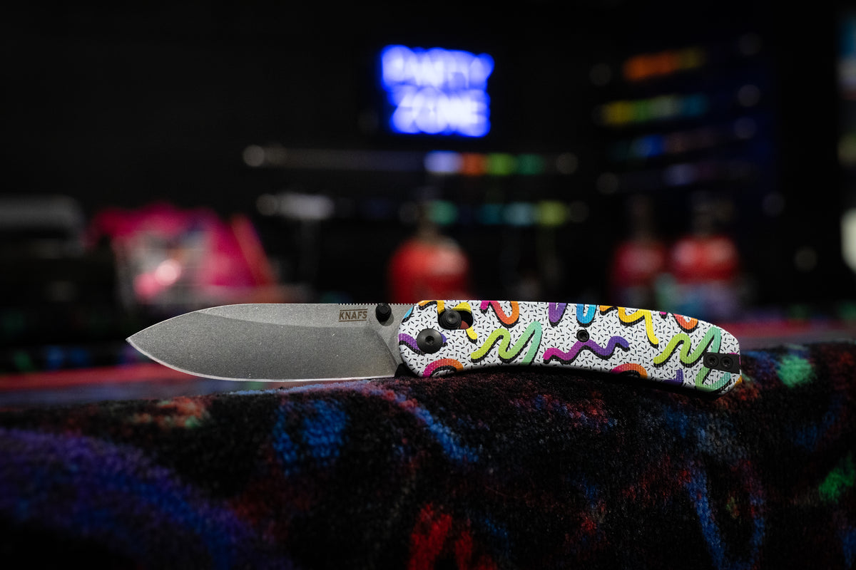 a folding knife with neon colored decoration