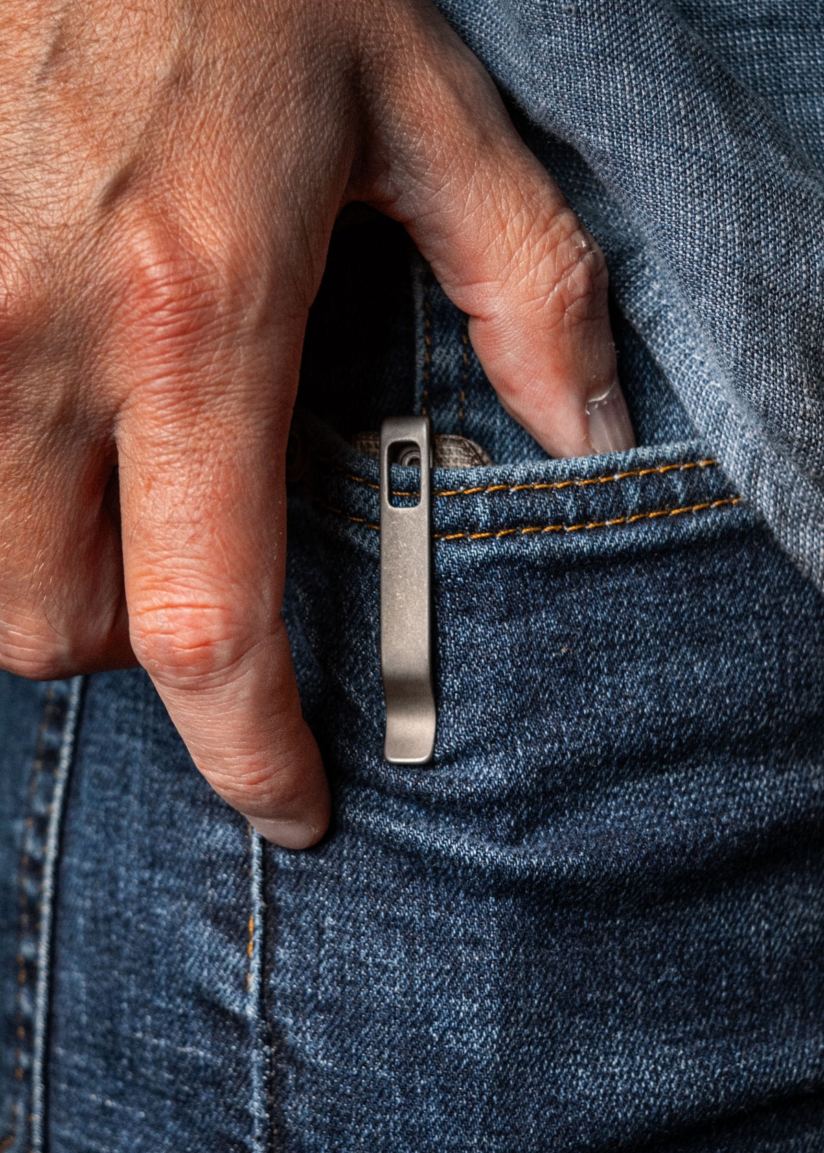 Close-up of Lander 7 pocket knife with Moondust micarta handle clipped inside jeans pocket