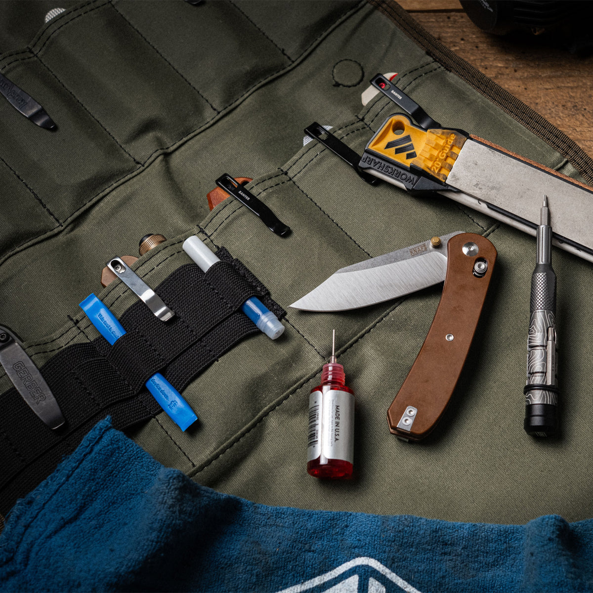 Burrito Grande Guac Edition EDC knife roll draped over edge of desk with knife and multitool visible