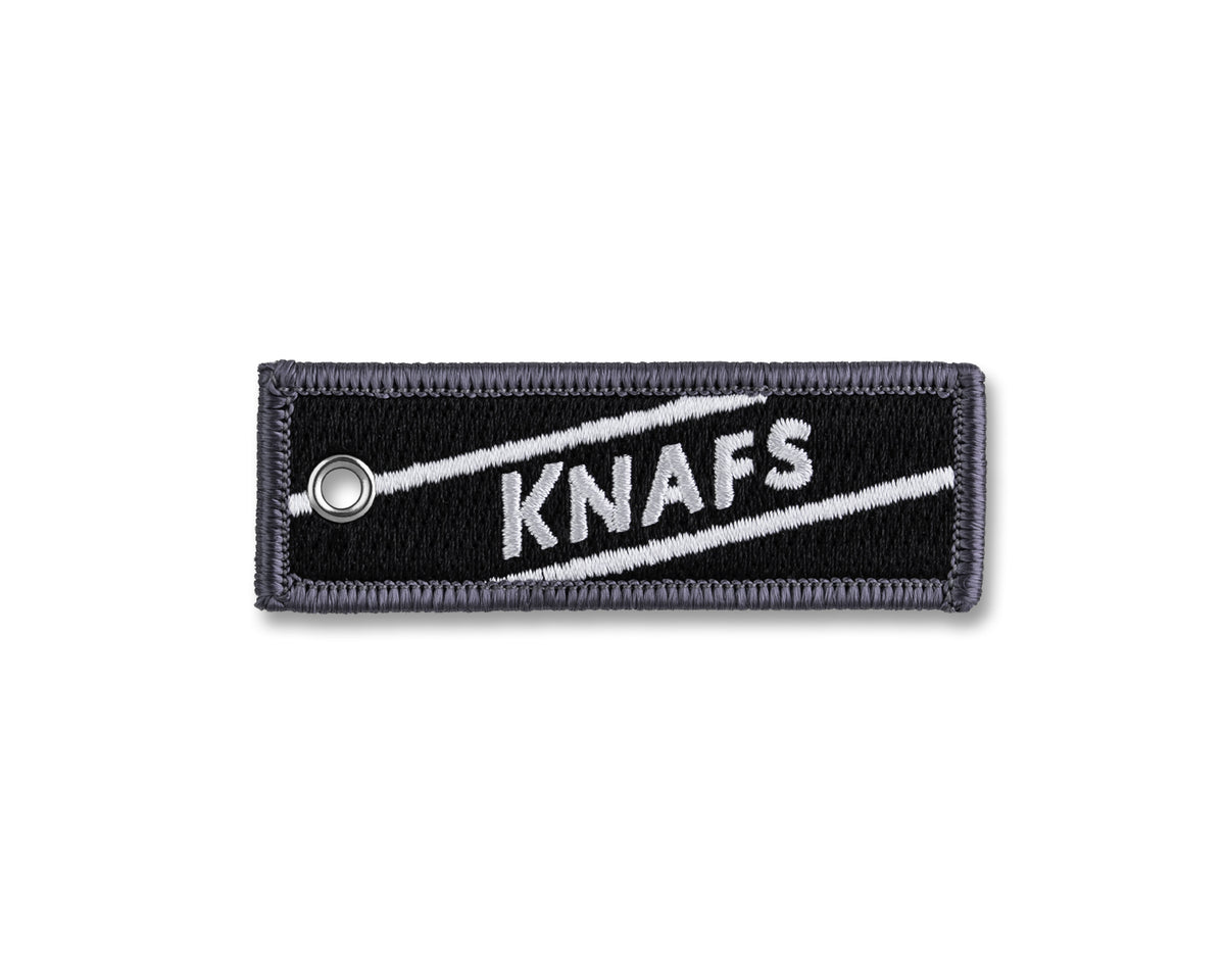 Knafs Flight Tag Ruler Keychain, a small black ruler tag with the Knafs logo, isolated product shot