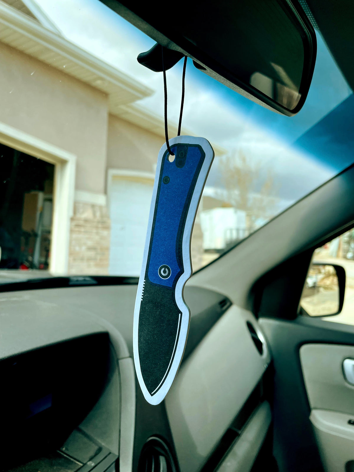 CIVIVI Knife Air Freshener hanging from a car's rearview mirror