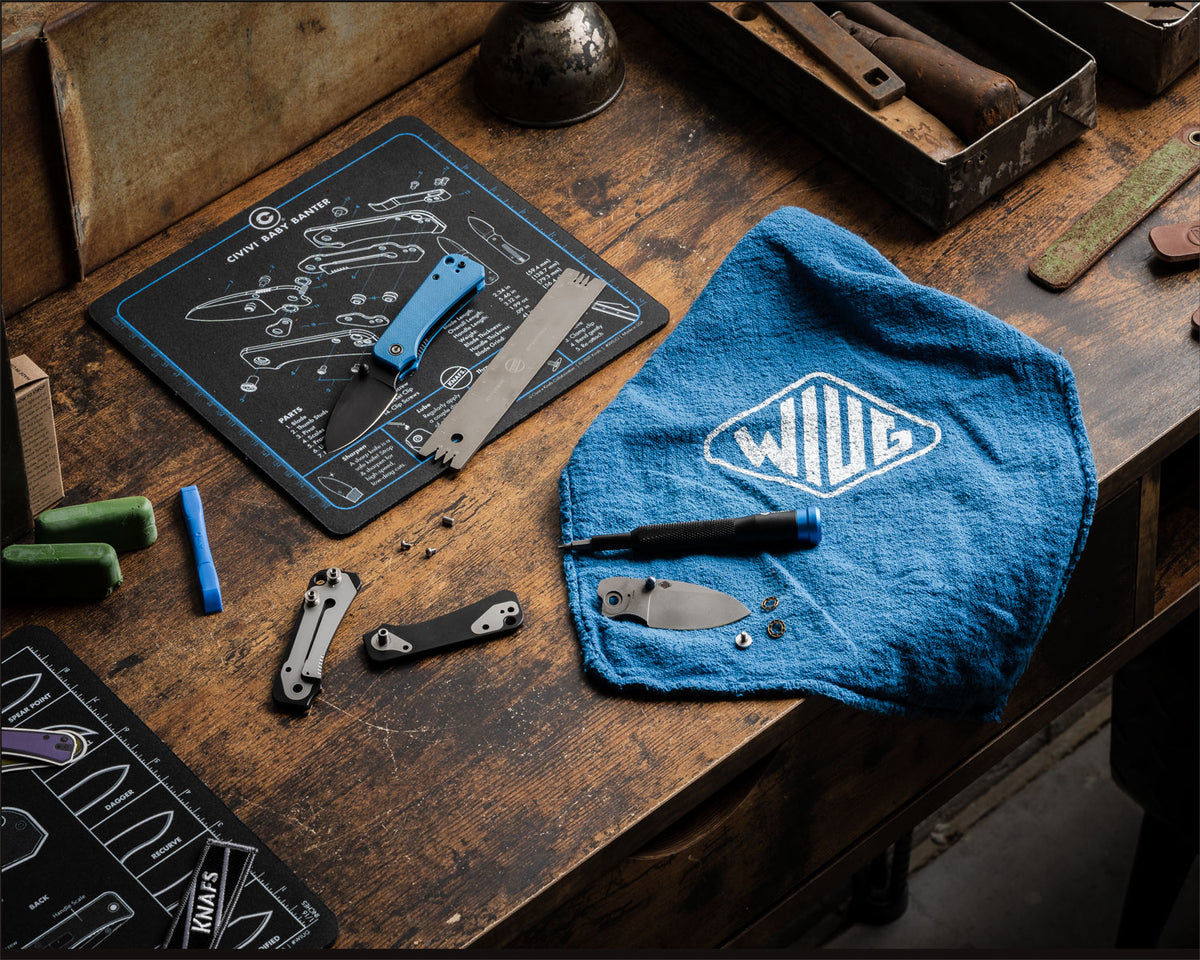 WIUG Shop Rag laid out on a workbench next to a knife and tools