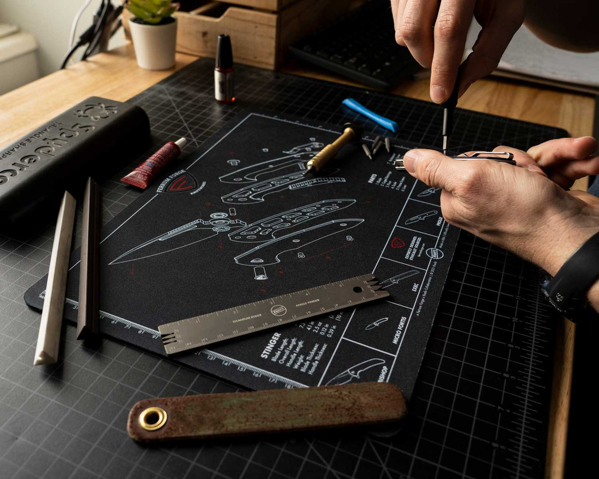 Knafs x Ferrum Forge Stinger Knife Shop Mat, hand reassembling the knife with a screwdriver