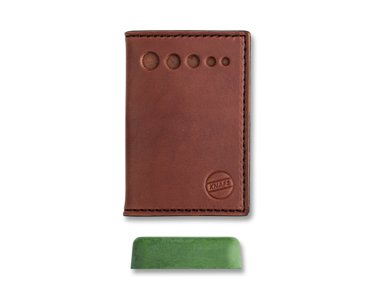 Leather Strop Wallet for Pocket Knives in oxblood leather, closed, shown with the included green stropping compound bar